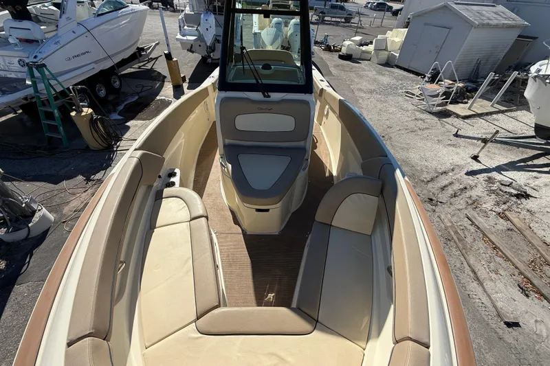 Slide: The Image of 2023 Chris-Craft Catalina 24 boat interior with beige seating and helm station. - 19
