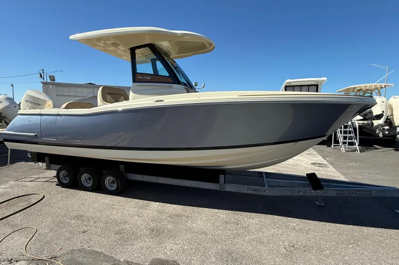 Slide: The Image of 2023 Chris-Craft Catalina 24 boat on trailer, displayed outdoors under clear blue sky. - 3