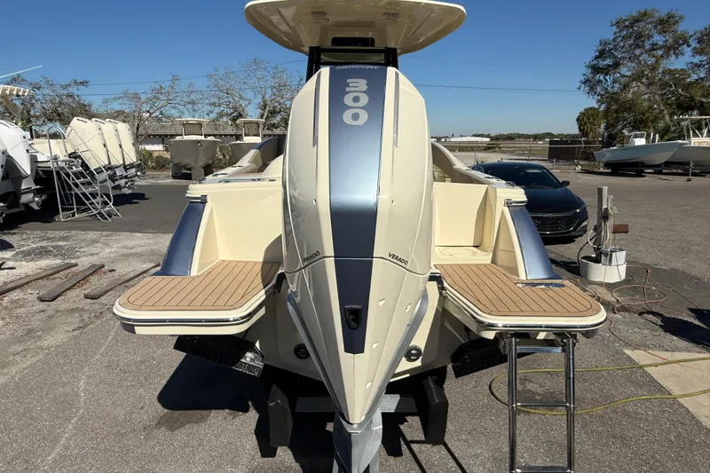 Slide: The Image of 2023 Chris-Craft Catalina 24 boat with powerful outboard engine, docked outdoors. - 4