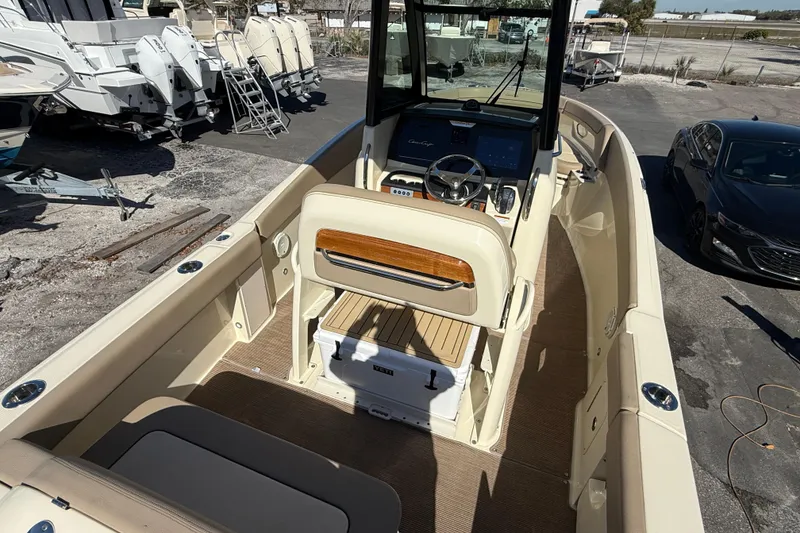Slide: The Image of 2023 Chris-Craft Catalina 24 boat interior with helm, seating, and storage. - 6