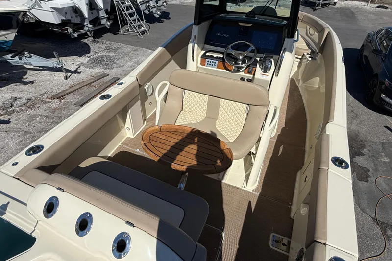 Slide: The Image of 2023 Chris-Craft Catalina 24 boat interior with beige seating and wooden accents. - 8