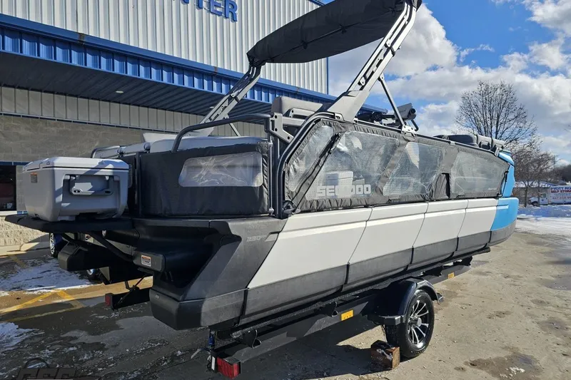 Slide: The Image of 2023 Sea-Doo Switch Cruise 21 pontoon boat on trailer, parked outdoors. - 10