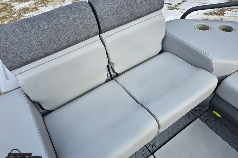 Slide: The Image of 2023 Sea-Doo Switch Cruise 21 boat seating with gray upholstery and cup holders. - 107