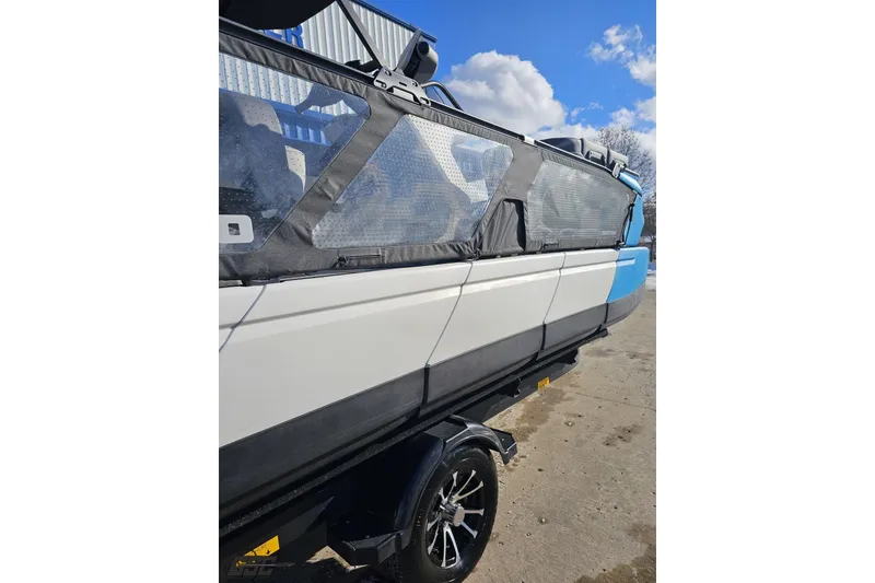 Slide: The Image of 2023 Sea-Doo Switch Cruise 21 pontoon boat on trailer, side view. - 12