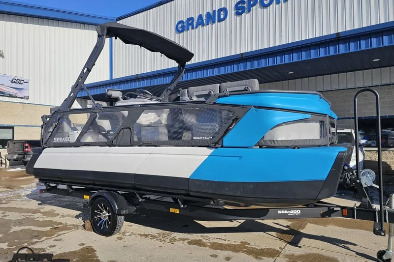 Slide: The Image of 2023 Sea-Doo Switch Cruise 21 pontoon boat on trailer outside dealership. - 15