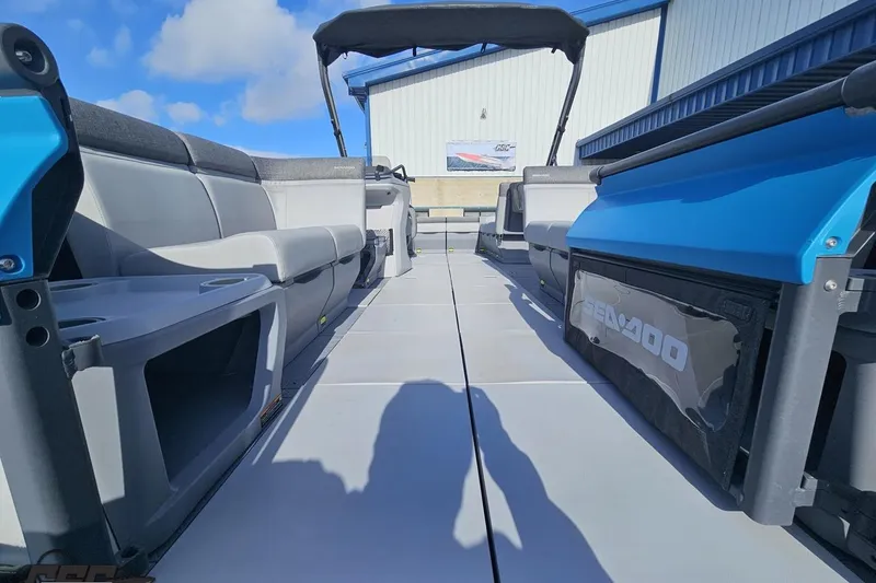 Slide: The Image of 2023 Sea-Doo Switch Cruise 21 interior with seating and storage, under a clear blue sky. - 22