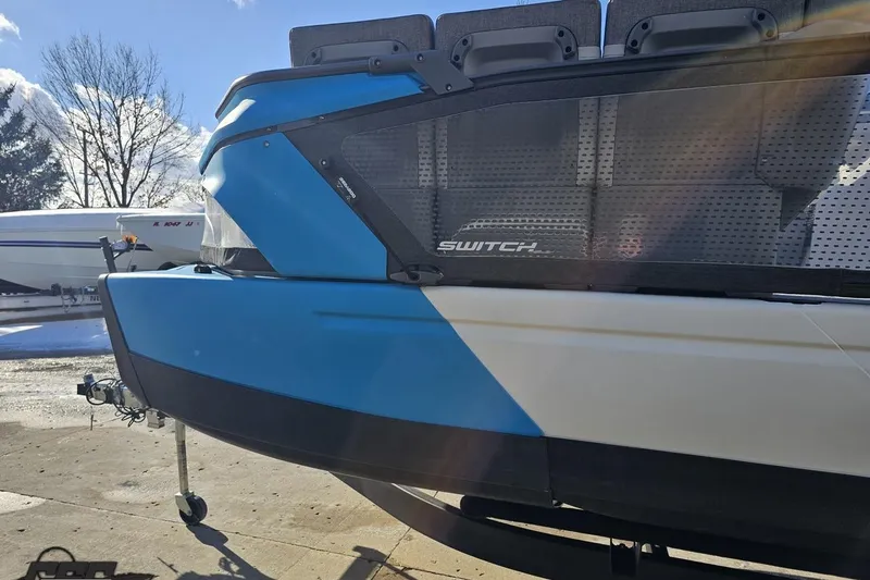 Slide: The Image of 2023 Sea-Doo Switch Cruise 21 pontoon boat in sunlight, showcasing sleek design and seating. - 27