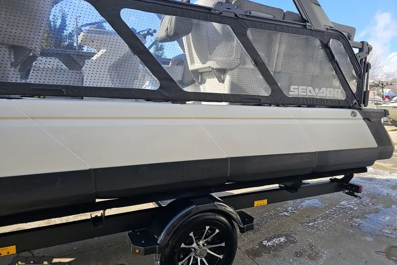 Slide: The Image of 2023 Sea-Doo Switch Cruise 21 on trailer, side view with visible seating and branding. - 29