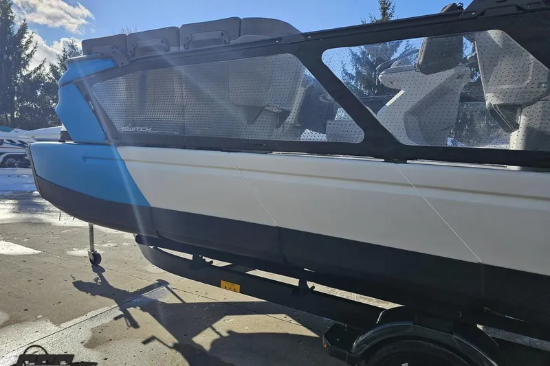 Slide: The Image of 2023 Sea-Doo Switch Cruise 21 boat on trailer, side view in sunlight. - 30