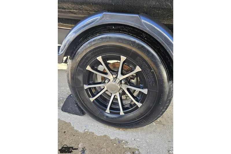 Slide: The Image of 2023 Sea-Doo Switch Cruise 21 trailer wheel with black tire and silver alloy rim. - 32