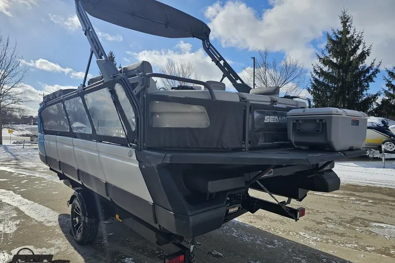 Slide: The Image of 2023 Sea-Doo Switch Cruise 21 pontoon boat on trailer, parked in snowy area. - 33
