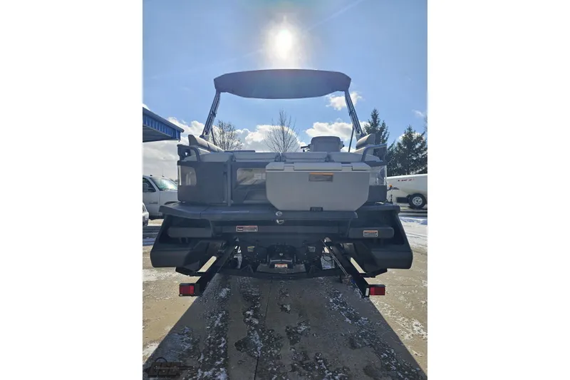 Slide: The Image of 2023 Sea-Doo Switch Cruise 21 pontoon boat, rear view, under sunny sky. - 35