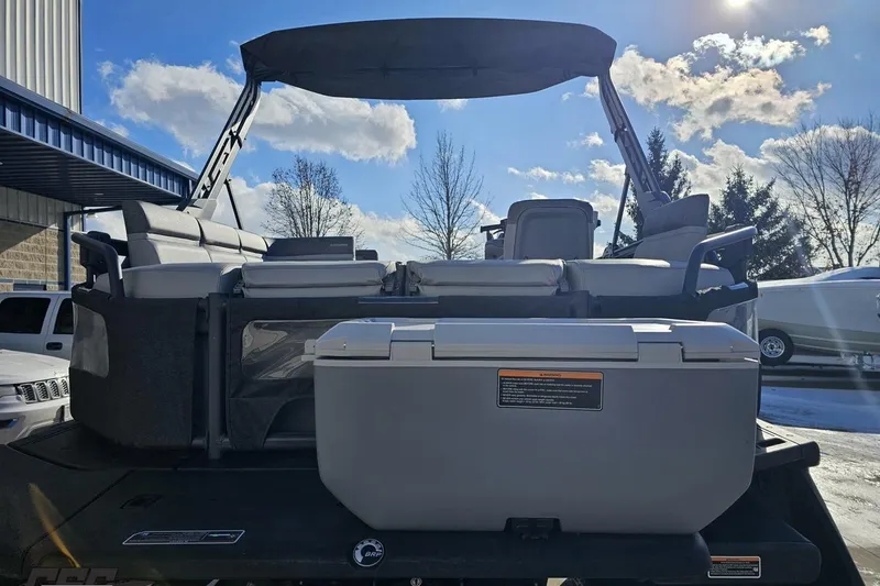 Slide: The Image of 2023 Sea-Doo Switch Cruise 21 pontoon boat with seating and storage, under a sunny sky. - 37