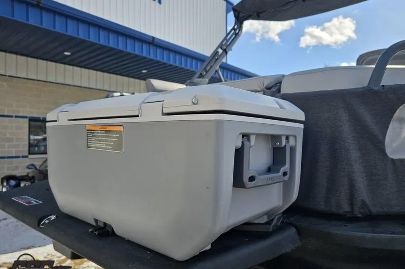 Slide: The Image of 2023 Sea-Doo Switch Cruise 21 with a mounted storage box, outdoor setting. - 38