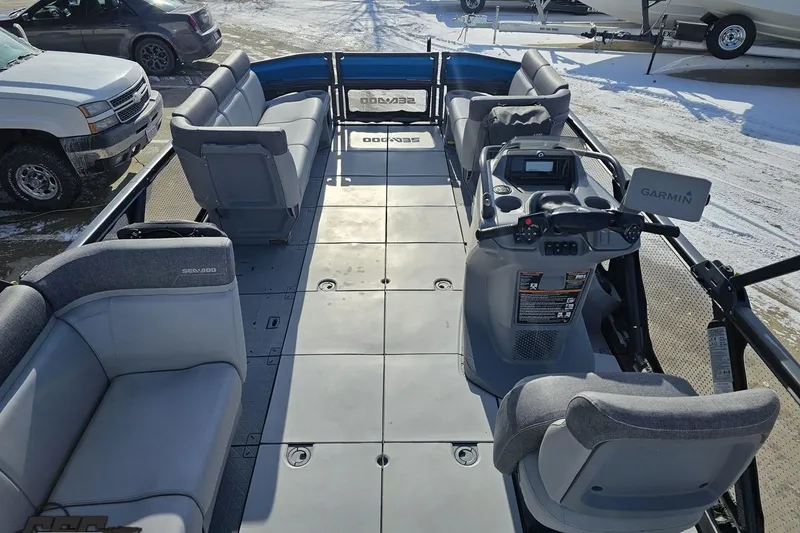 Slide: The Image of 2023 Sea-Doo Switch Cruise 21 pontoon boat interior with seating and control console. - 46
