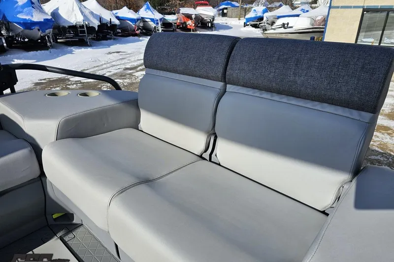 Slide: The Image of 2023 Sea-Doo Switch Cruise 21 interior seating with cup holders, in a snowy outdoor setting. - 53