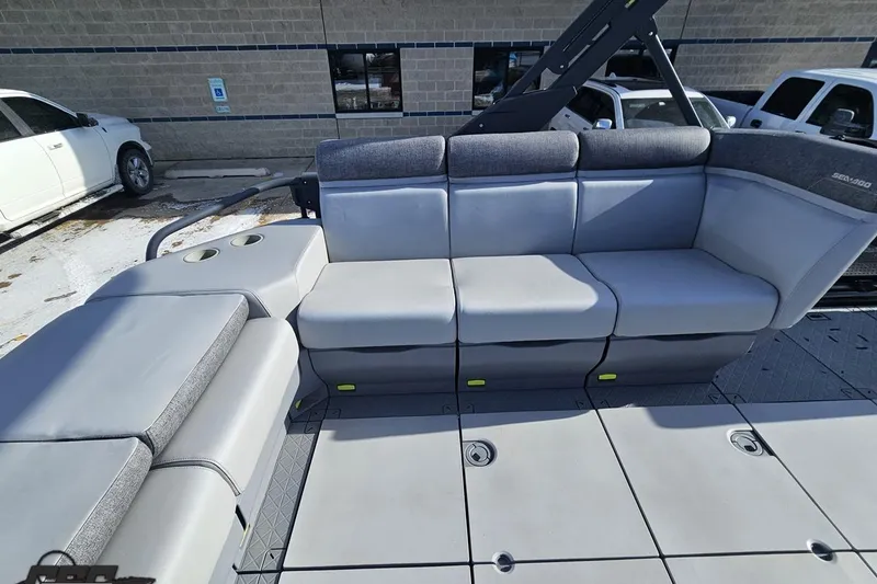 Slide: The Image of 2023 Sea-Doo Switch Cruise 21 interior with gray seating and cup holders. - 56