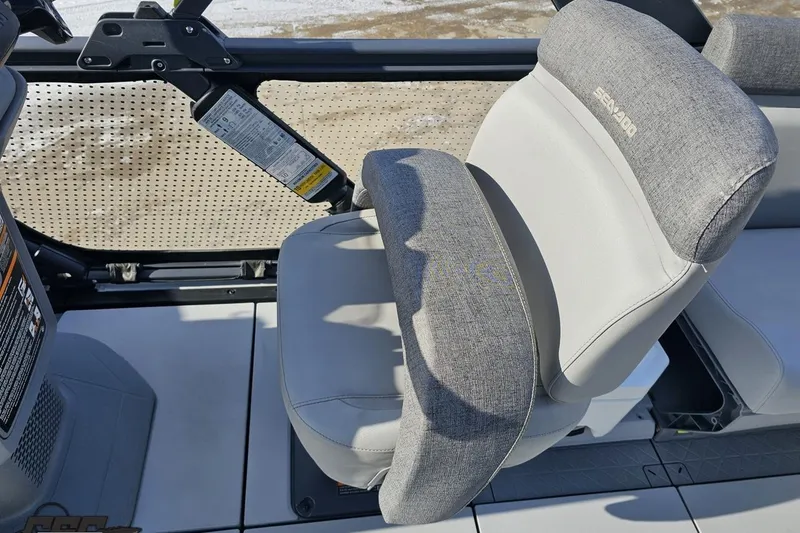 Slide: The Image of 2023 Sea-Doo Switch Cruise 21 boat seat with gray upholstery and armrest. - 64