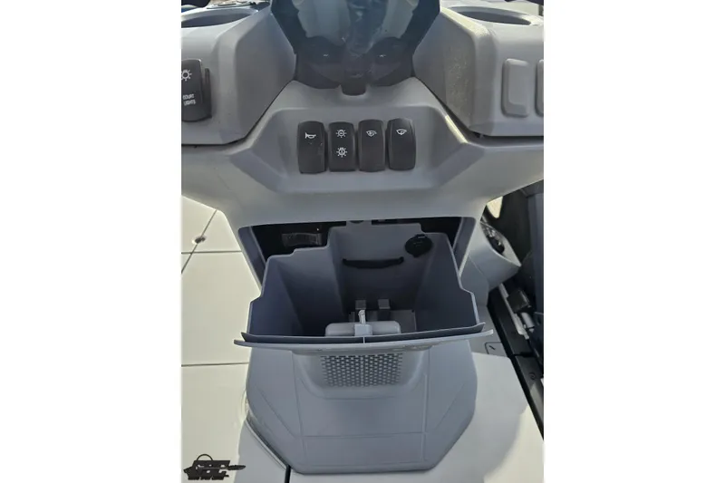 Slide: The Image of 2023 Sea-Doo Switch Cruise 21 dashboard with storage compartment and control buttons. - 75