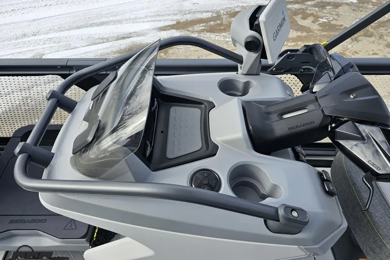 Slide: The Image of 2023 Sea-Doo Switch Cruise 21 dashboard with Garmin navigation system and cup holders. - 86