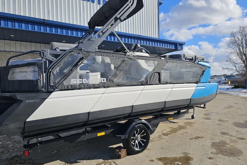 Slide: The Image of 2023 Sea-Doo Switch Cruise 21 pontoon boat on trailer, parked outdoors. - 9