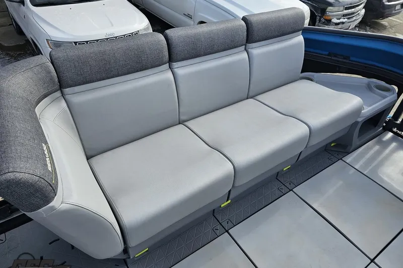 Slide: The Image of 2023 Sea-Doo Switch Cruise 21 boat seating, featuring gray upholstery and integrated cup holders. - 91