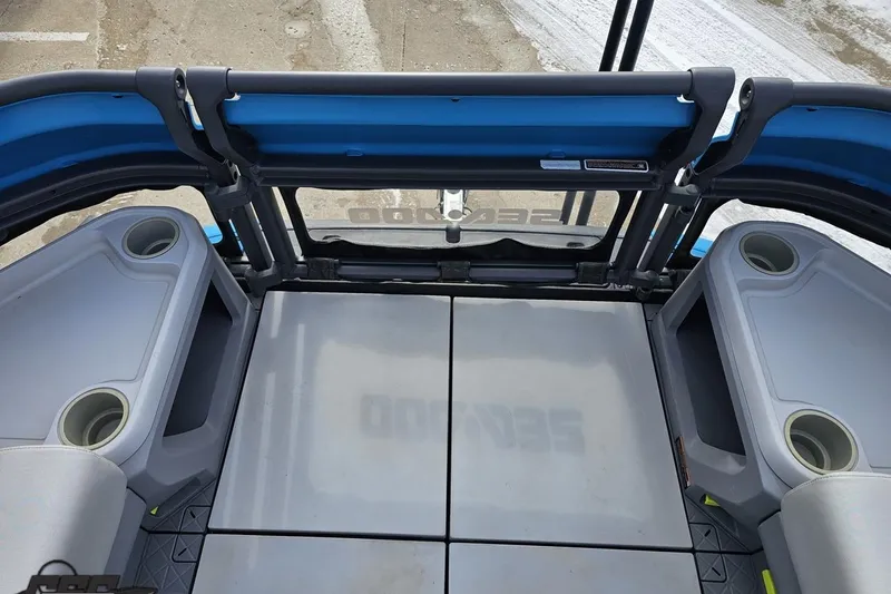 Slide: The Image of 2023 Sea-Doo Switch Cruise 21 interior with seating and cup holders, showcasing modern design. - 93