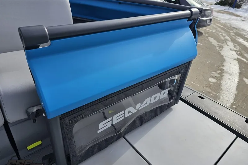 Slide: The Image of 2023 Sea-Doo Switch Cruise 21 with blue cover and logo, parked on snowy pavement. - 98