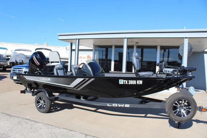 The Image of 2023 Lowe Skorpion 17 boat on trailer, parked outside dealership. - 1
