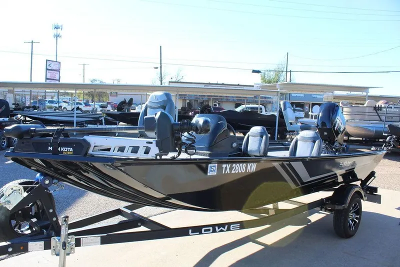 Slide: The Image of 2023 Lowe Skorpion 17 fishing boat on trailer, displayed outdoors. - 3