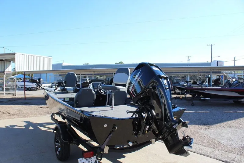 Slide: The Image of 2023 Lowe Skorpion 17 boat with Mercury engine, parked outdoors in a dealership lot. - 5