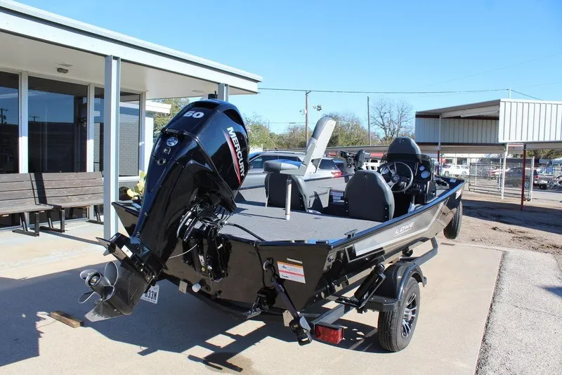 Slide: The Image of 2023 Lowe Skorpion 17 boat with Mercury 60 engine, parked outdoors. - 8