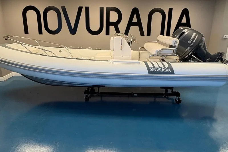 The Image of 2025 Novurania DL 550 boat with Yamaha 115 engine displayed indoors. - 0