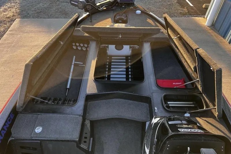 Slide: The Image of 2023 Skeeter ZX200 boat interior with storage compartments and fishing gear. - 12