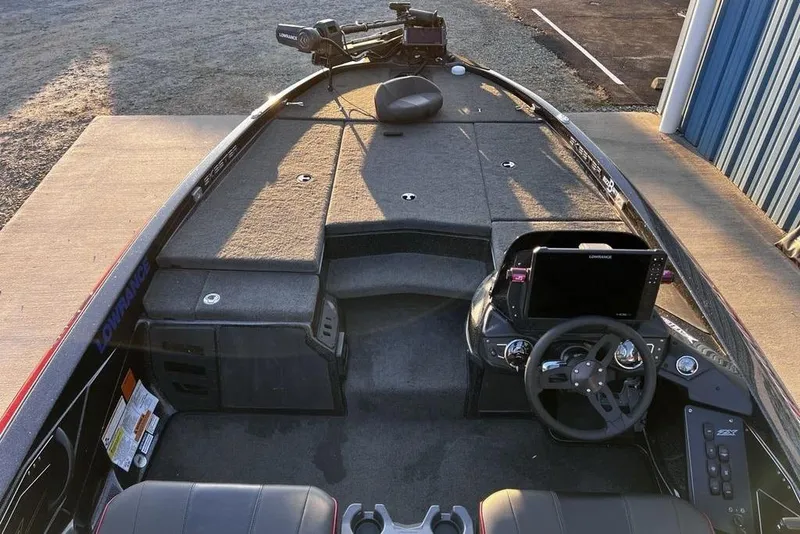 Slide: The Image of 2023 Skeeter ZX200 boat interior with steering wheel and navigation system. - 14
