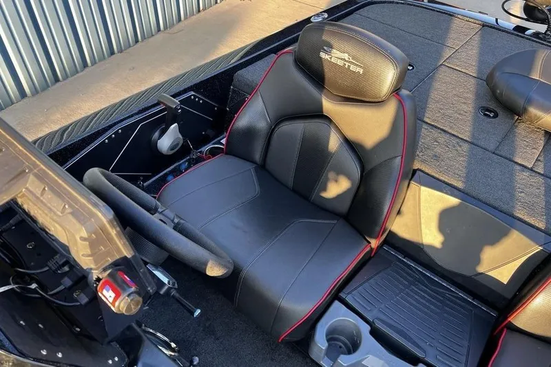 Slide: The Image of 2023 Skeeter ZX200 boat cockpit with black leather seat and steering wheel. - 15