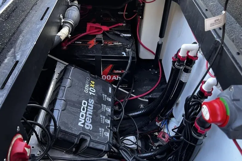 Slide: The Image of 2023 Skeeter ZX200 boat battery compartment with NOCO Genius charger and wiring. - 16