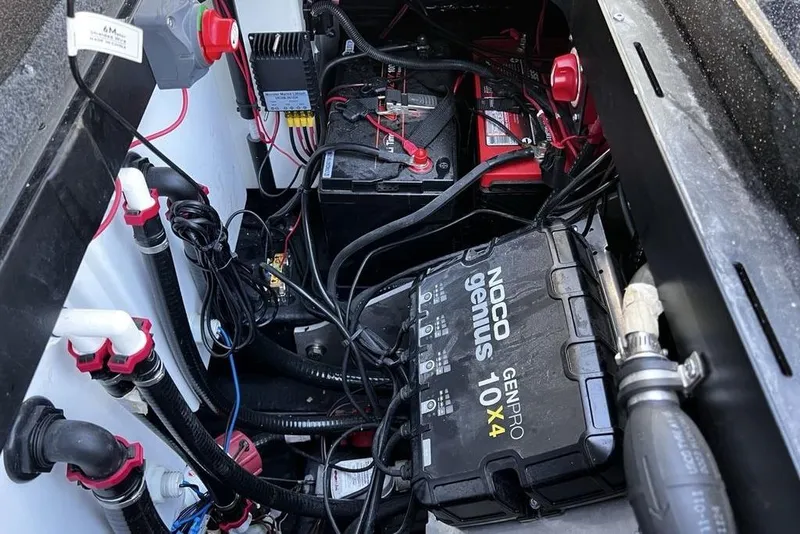 Slide: The Image of 2023 Skeeter ZX200 boat battery compartment with NOCO Genius charger and wiring. - 20