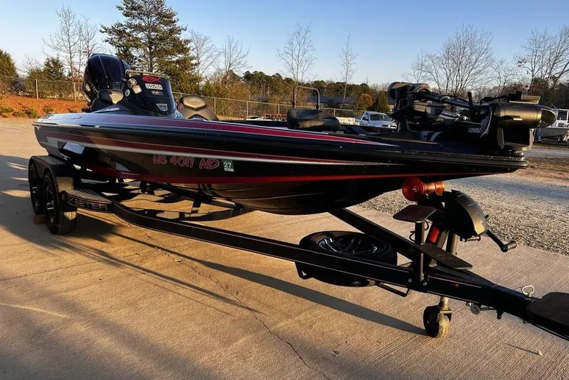 Slide: The Image of 2023 Skeeter ZX200 boat on trailer, parked outdoors in a sunny setting. - 21