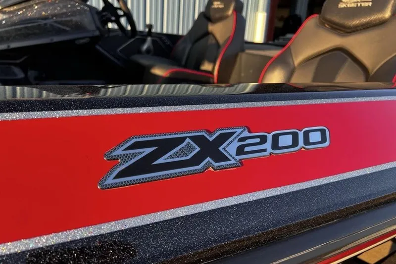 Slide: The Image of 2023 Skeeter ZX200 boat with red and black detailing, featuring sleek interior seats. - 5