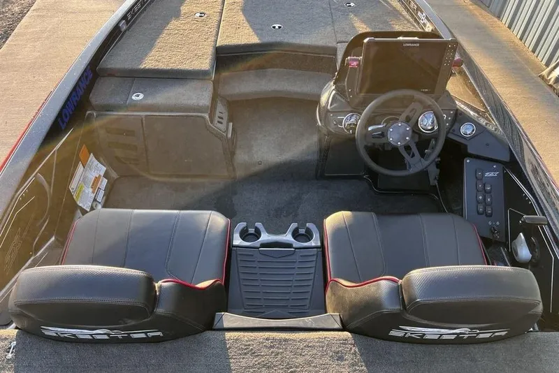Slide: The Image of 2023 Skeeter ZX200 boat interior with steering wheel and seating. - 7
