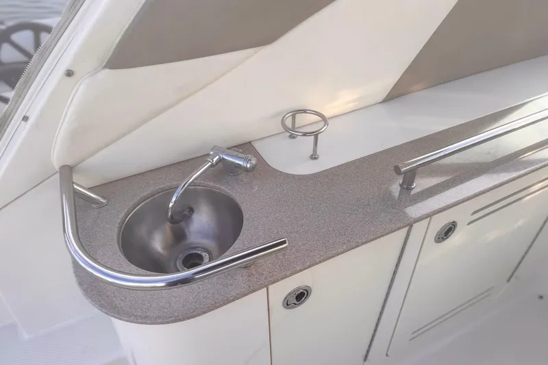 Slide: The Image of 2007 Sea Ray Sundancer 310 boat sink with stainless steel faucet and countertop. - 12