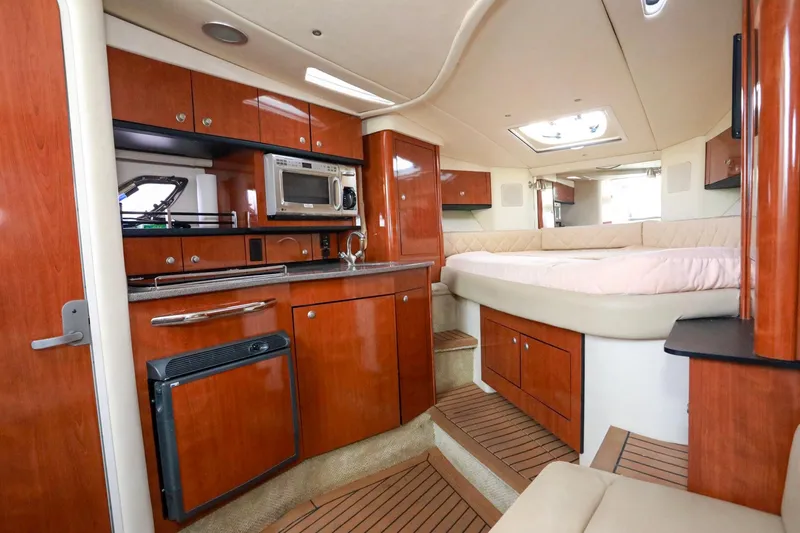 Slide: The Image of Luxurious 2007 Sea Ray Sundancer 310 cabin interior with kitchenette and cozy sleeping area. - 14