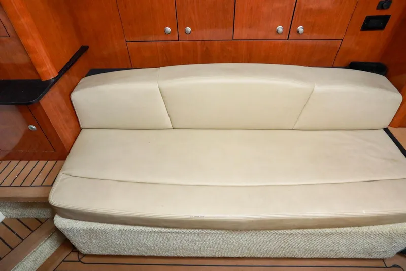 Slide: The Image of 2007 Sea Ray Sundancer 310 interior with beige leather seating and wooden cabinetry. - 16