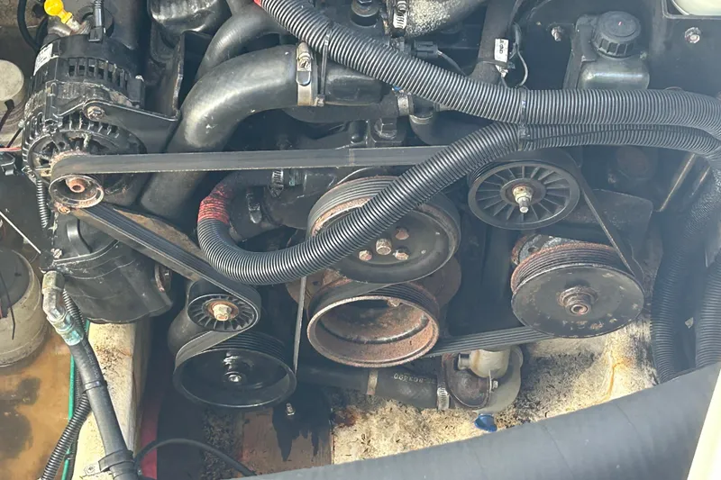 Slide: The Image of Engine components of a 2007 Sea Ray Sundancer 310 boat, featuring belts and pulleys. - 26