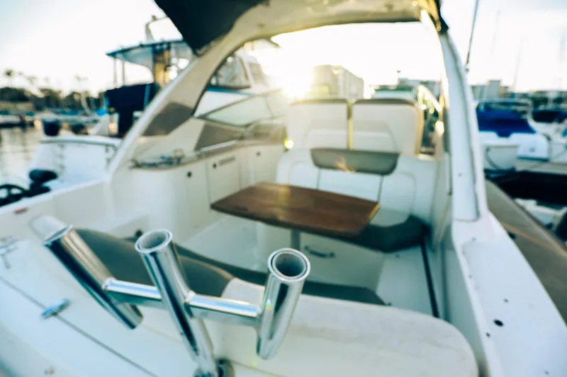 Slide: The Image of 2007 Sea Ray Sundancer 310 interior with seating and table, docked at marina. - 6