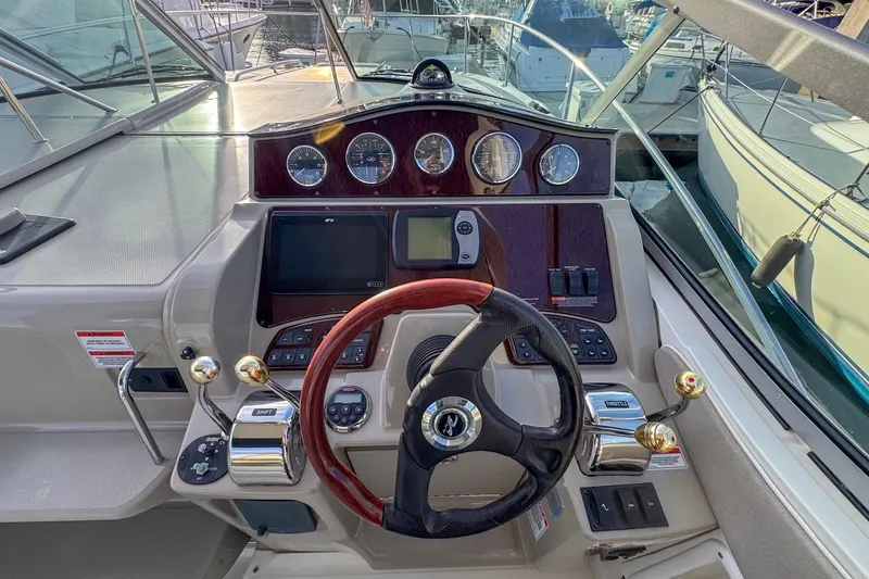 Slide: The Image of 2007 Sea Ray Sundancer 310 helm with steering wheel, gauges, and controls. - 8