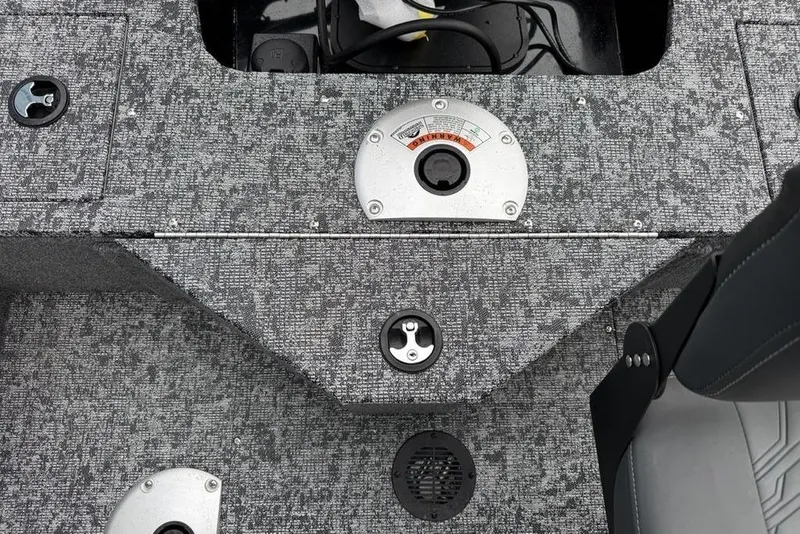 Slide: The Image of 2026 Tracker Pro Guide V-16 SC boat interior with textured flooring and control panel. - 14