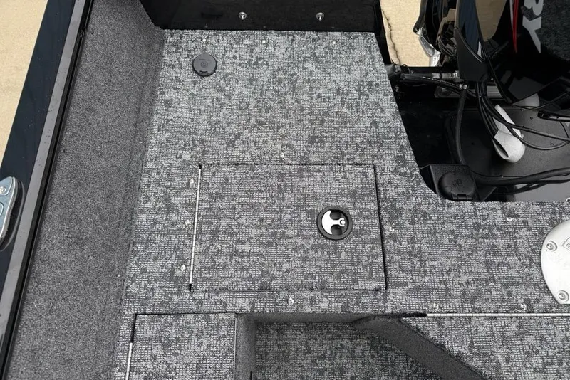 Slide: The Image of 2026 Tracker Pro Guide V-16 SC boat interior with textured flooring and storage compartment. - 15