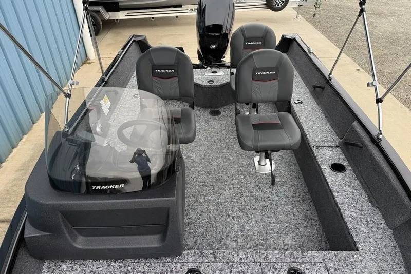 Slide: The Image of 2026 Tracker Pro Guide V-16 SC boat interior with seating and steering console. - 7